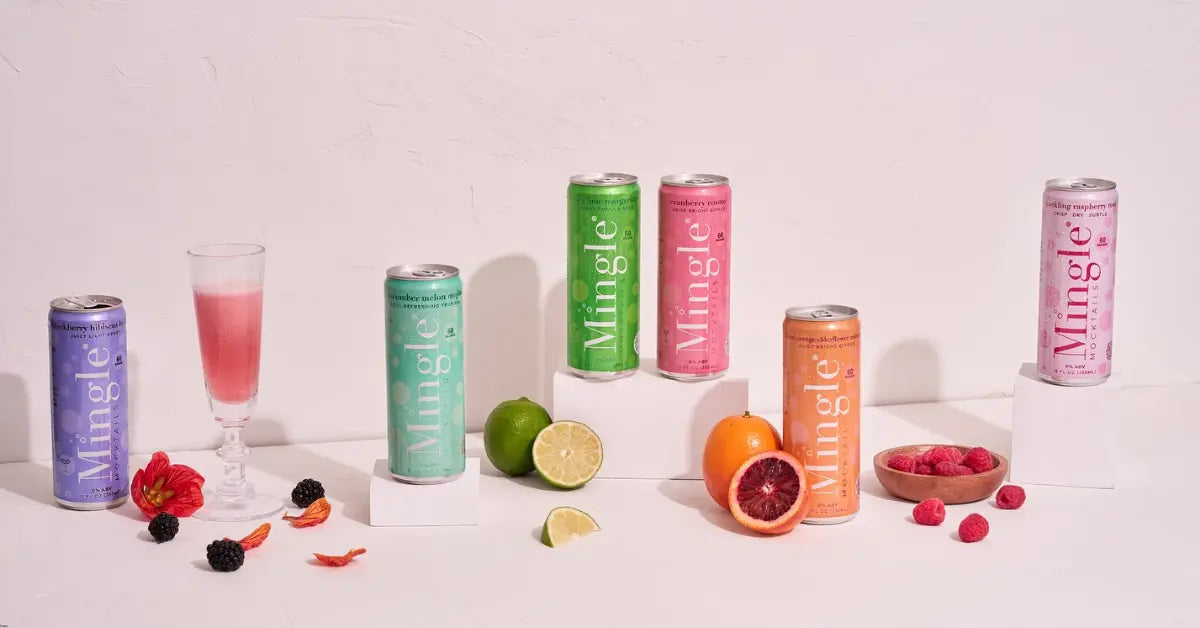 Buy mocktails online featuring Mingle Mocktails in various flavors, surrounded by fresh fruits and a glass of a mixed drink.