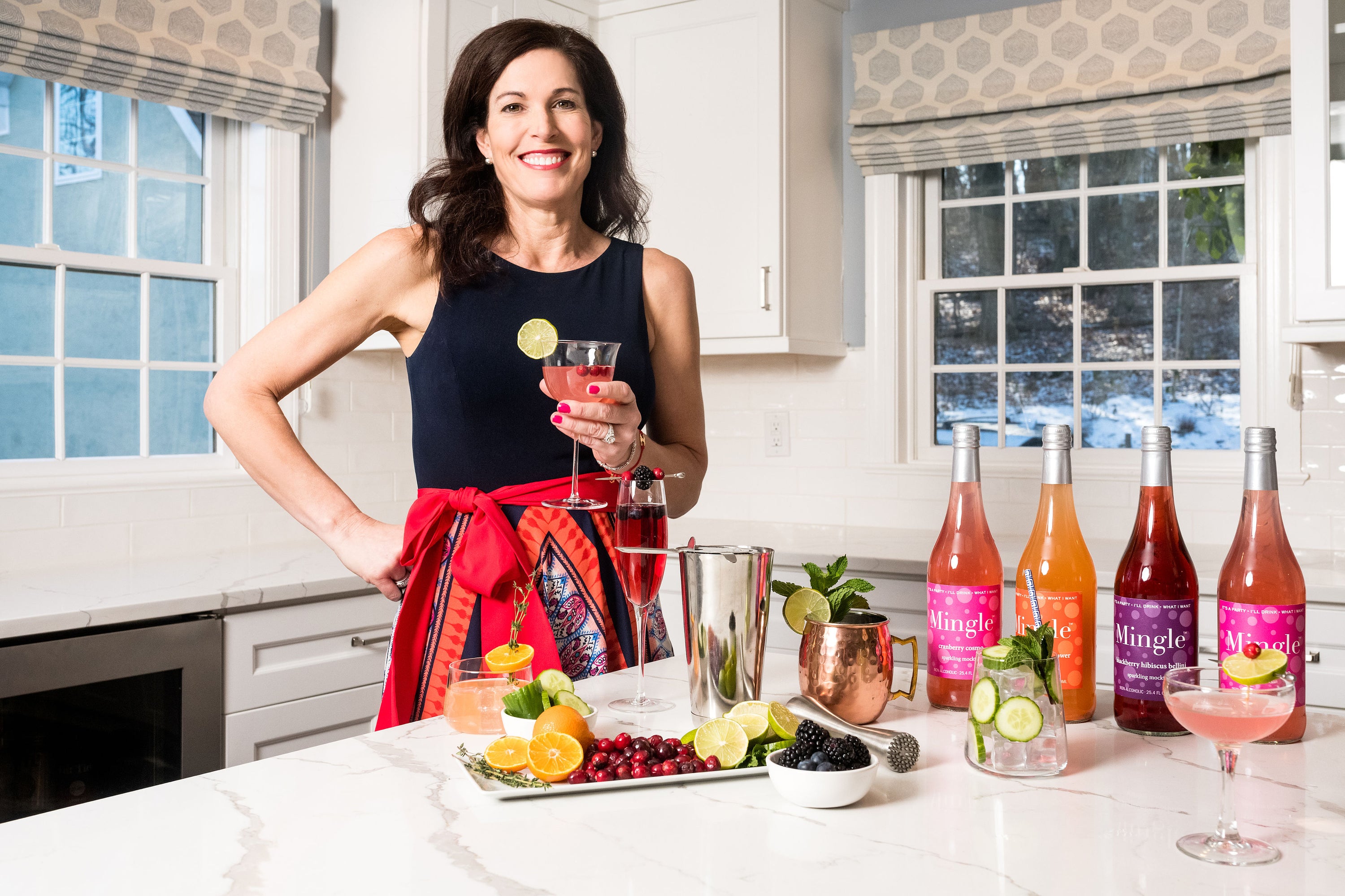 Laura_holding_another_glass_at_island_portrait.jpg__PID:347cf880-b643-42fe-a281-d4a059a1fdfc