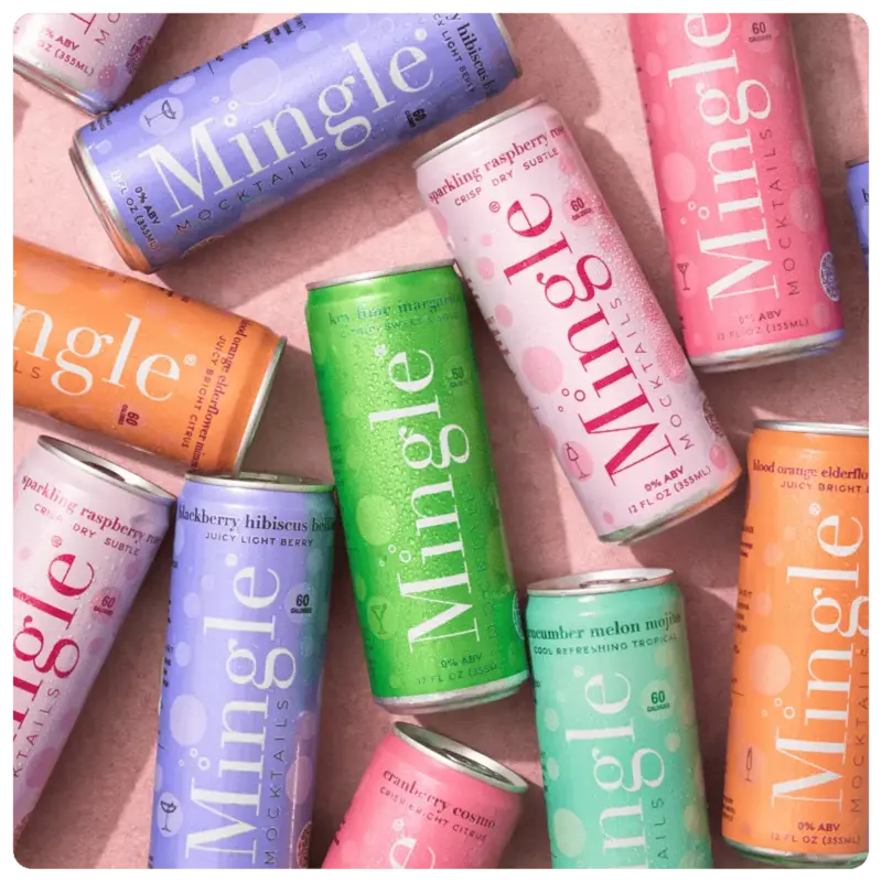 Assorted colorful Mingle Mocktails cans arranged on a light background, showcasing various flavors and vibrant packaging