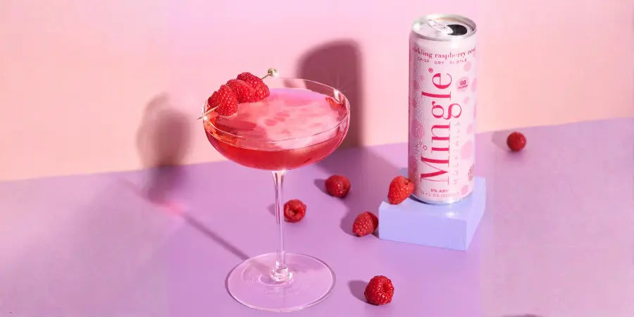 Alcohol-free cocktails with sparkling raspberry mocktail in coupe glass beside canned drink