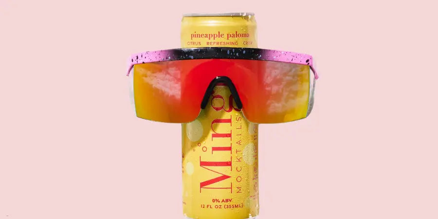 Mocktail Variety Packs spotlighting a Mingle Pineapple Paloma can wearing red-orange sunglasses.