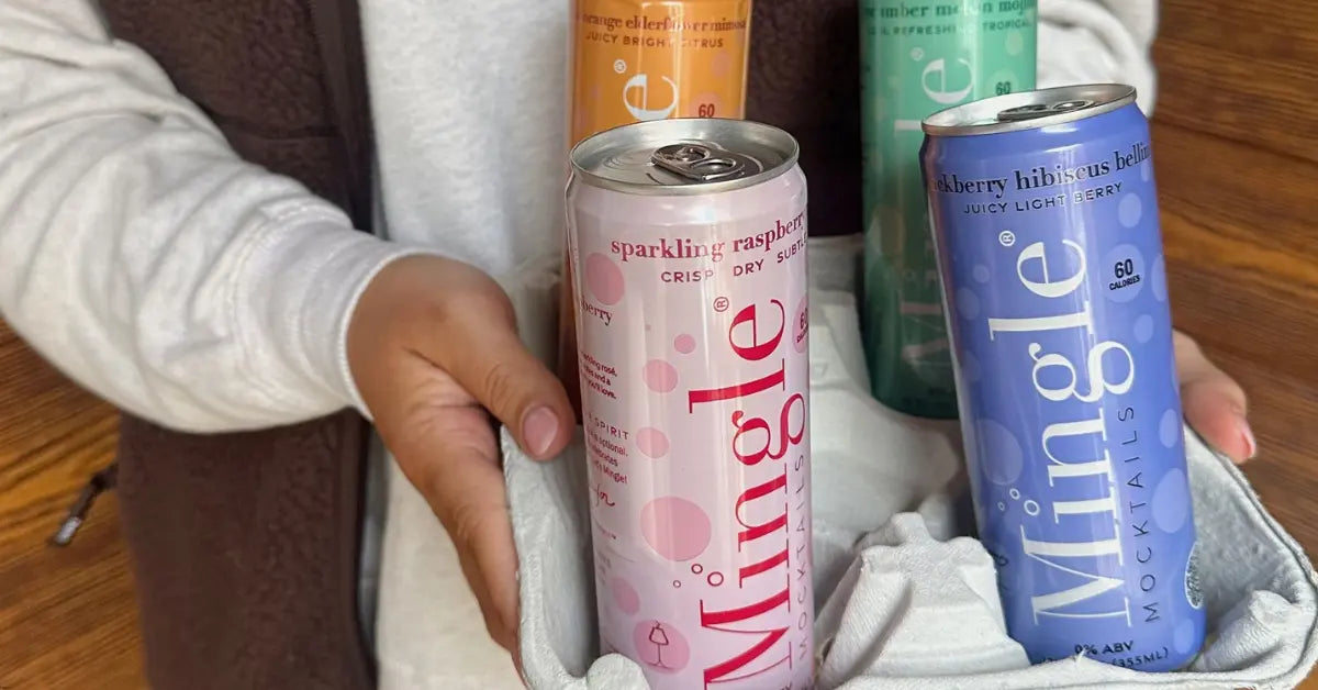 Cocktails without alcohol in colorful Mingle Mocktails cans held in a cloth-lined basket