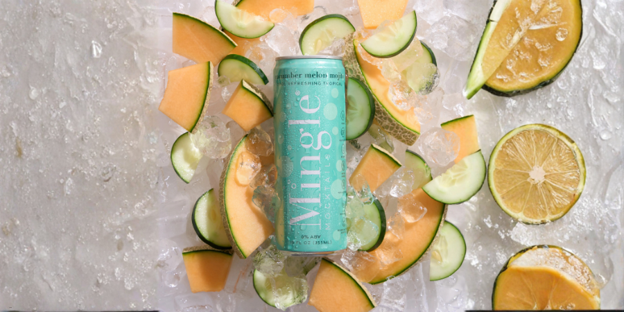 Non-alcoholic cocktails with cucumber melon mocktail surrounded by fresh melon and citrus slices