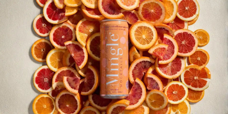 Non-alcoholic mimosa can displayed on background of sliced oranges and grapefruits