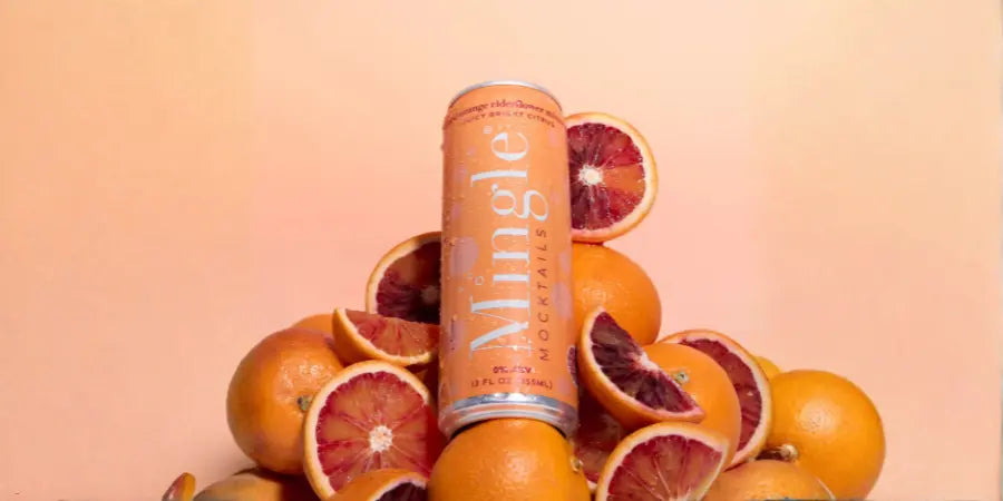 Mimosa-style mocktail can chilled among fresh blood orange halves and whole citrus