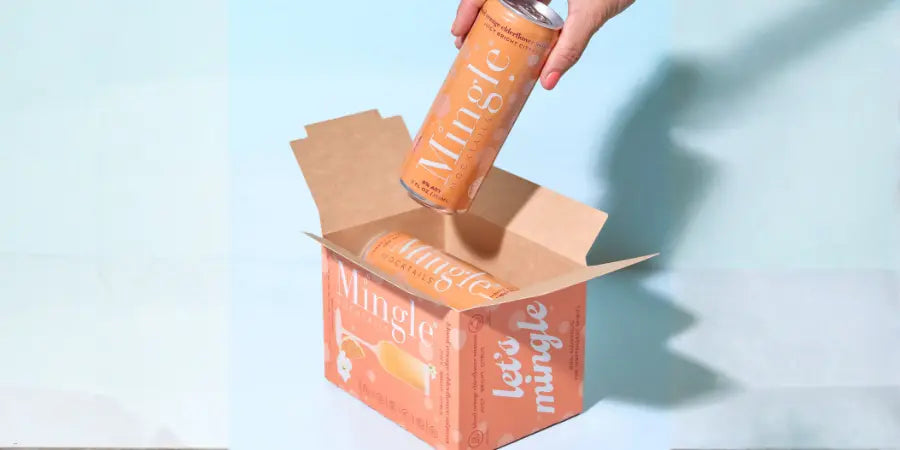 Premium mocktail mimosa beverage cans featuring orange elderflower in branded cardboard box
