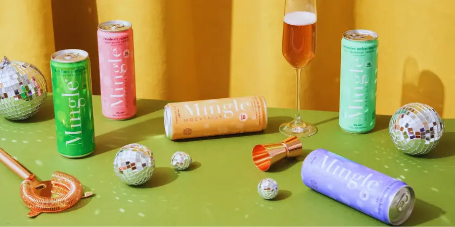 Creative brunch drinks displayed on a vibrant table with Mingle mocktails, disco balls, and a champagne flute.