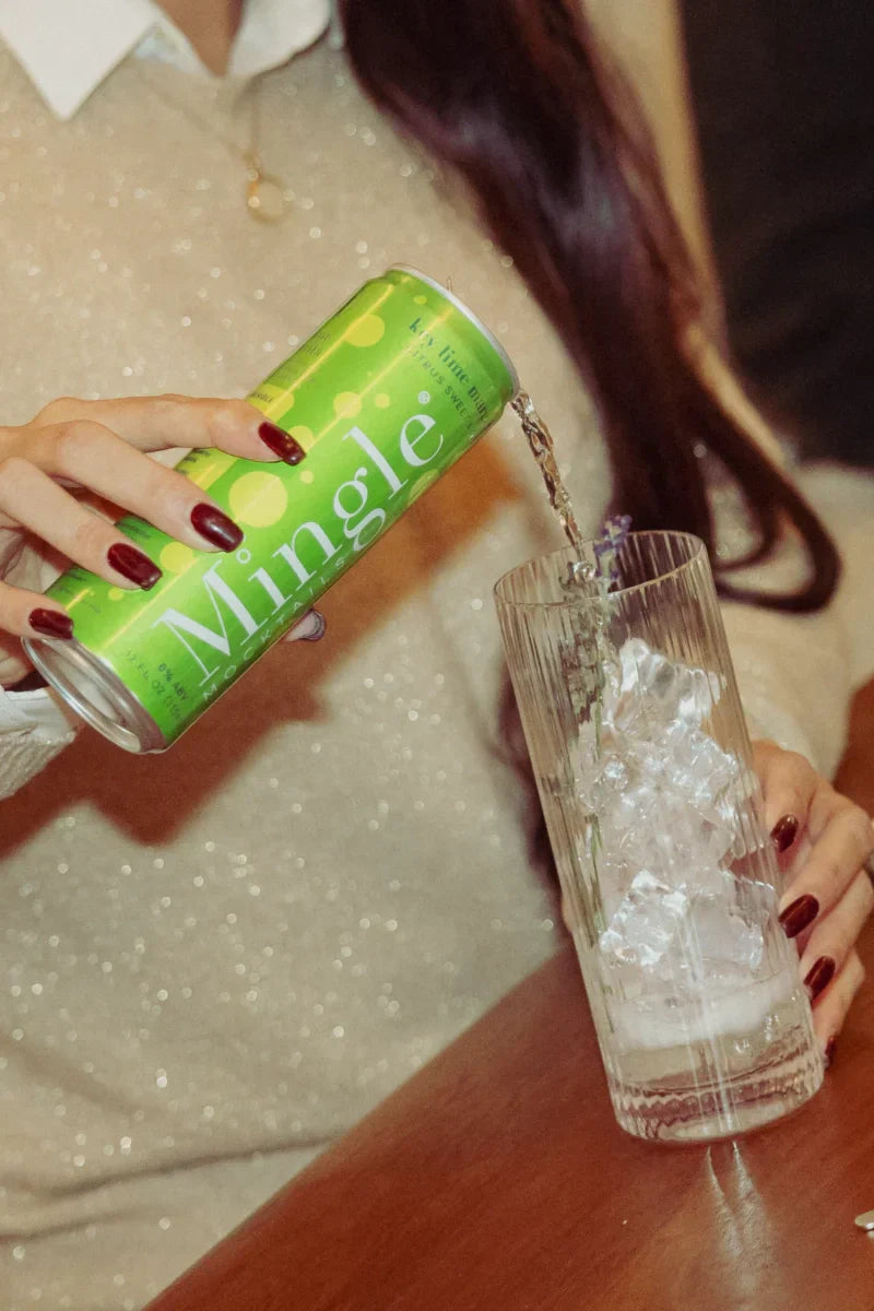 mingle mocktails being poured into a glass at a dinner party