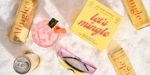 A snowy scene showcases mocktails for Dry January, with Mingle's Pineapple Paloma and a vibrant pink cocktail