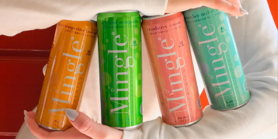 A person cradles four Mingle Mocktails cans, showcasing colorful and convenient ready-made mocktails in various flavors