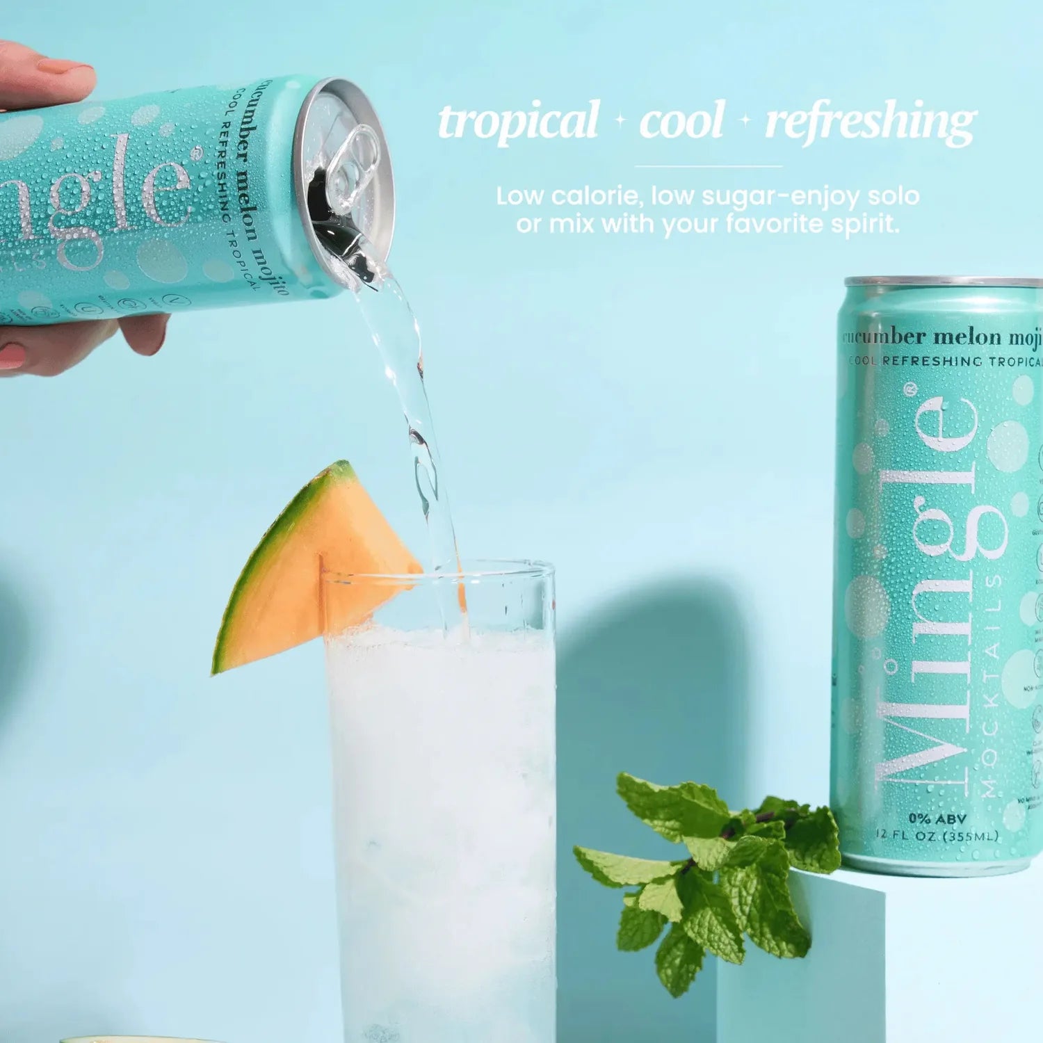 Mingle Mocktails Cucumber Melon Mojito being poured from a turquoise can into a glass garnished with melon and fresh mint.